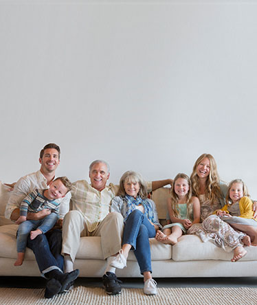 large-family-sitting-on-a-white-couch