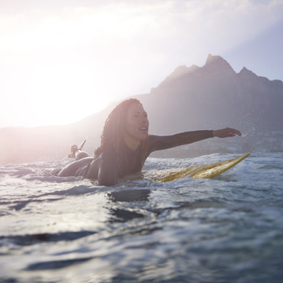 Lady paddling on a surfboard